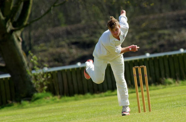A Cricket bowler in action.